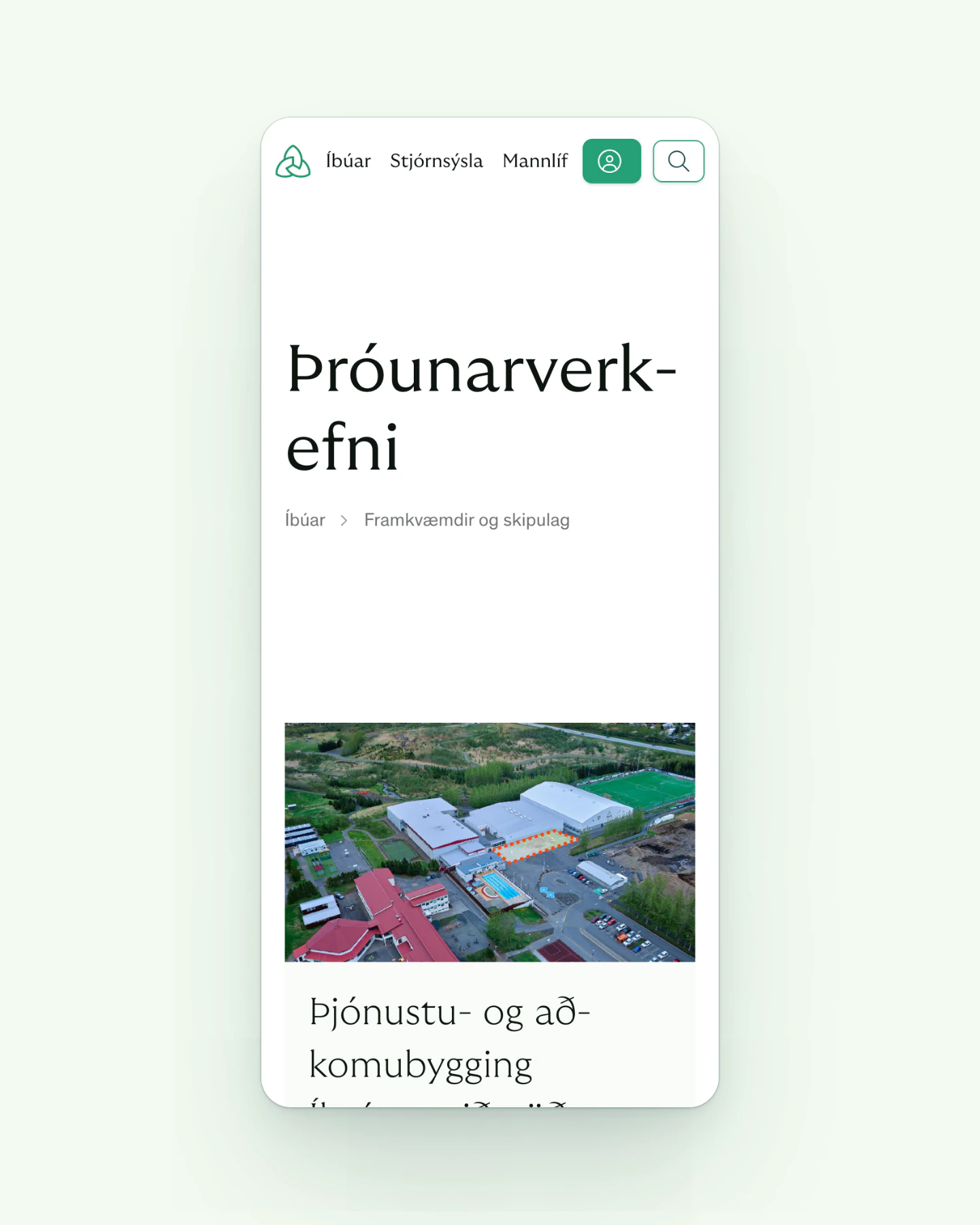 A phone screen showing the Mosfellsbær website, with a triangular knot logo, menu links for Íbúar, Stjórnsýsla and Mannlíf, and green account and search buttons. The heading "Þróunarverkefni" sits below, followed by a breadcrumb trail. Further down, an aerial photo shows a swimming pool, a sports hall and car parks above a project title.